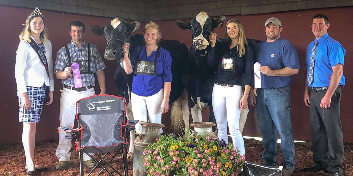 A cow in the Senior 3-Year-Old class ranked second in its class and went on to receive the title of Reserve Intermediate Champion, as well as Honorable Mention Grand Champion of the show. Pictured third from right is sophomore Maddy Gwidt, and pictured second from right is Cory Weigel, dairy enterprise manager at Pioneer Farm.