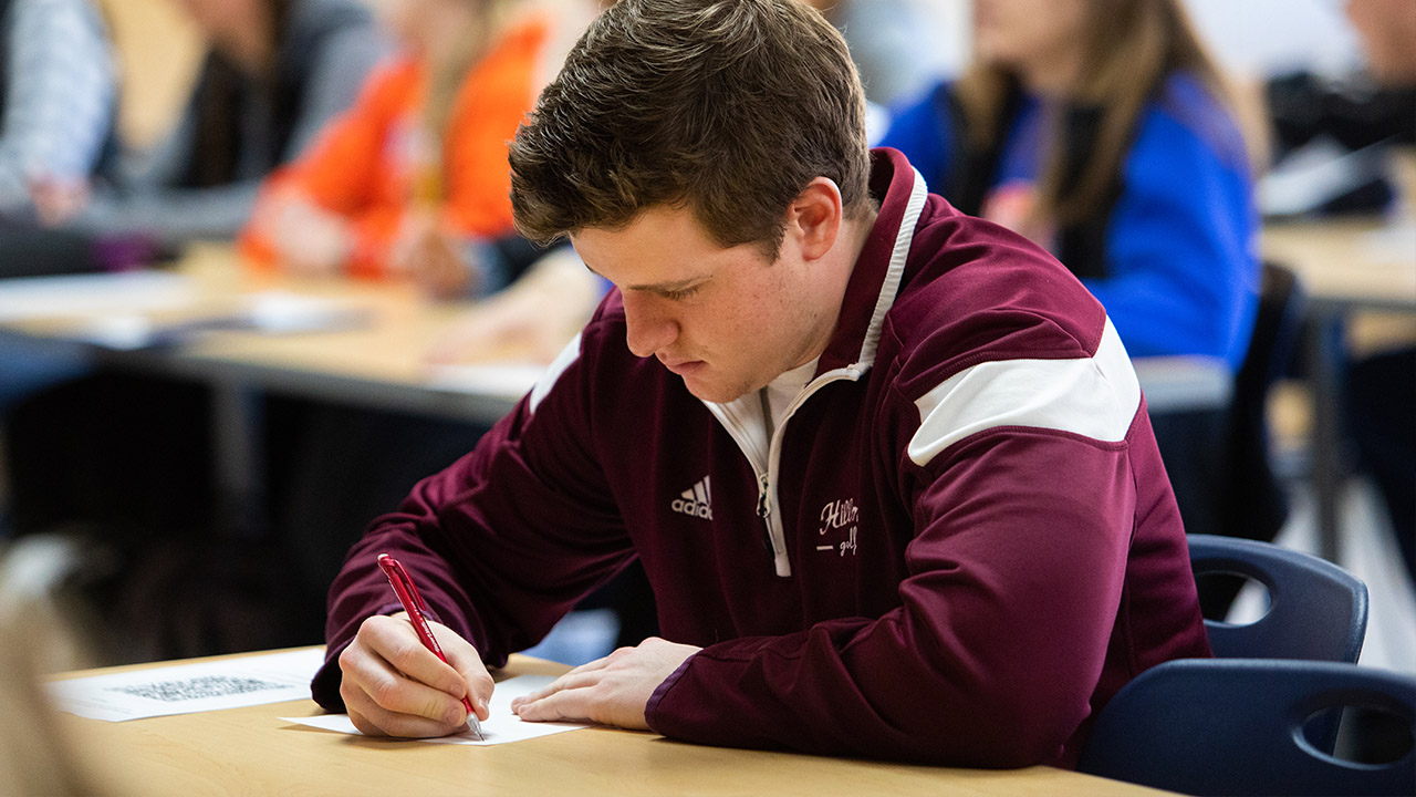 Isaiah Altfillisch, Health and Human Performance - Physical Education major, listening intently to education presenters.