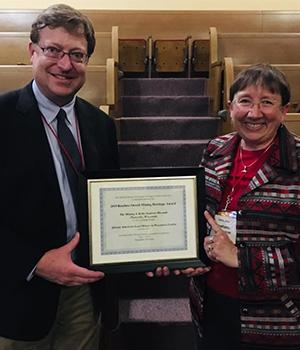 Erik Flesch, Director of the Mining and Rollo Jamison Museums and Stephanie Saager Bourrett, former curator of the Mining and Rollow Jamison Museums accept the award certifiate