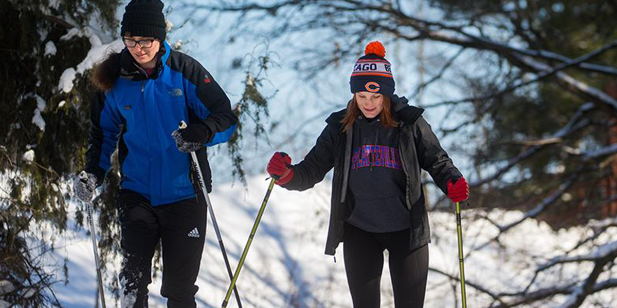 Two students cross-country skiing