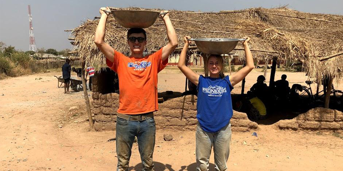 Brendan and Taylor carrying baskets