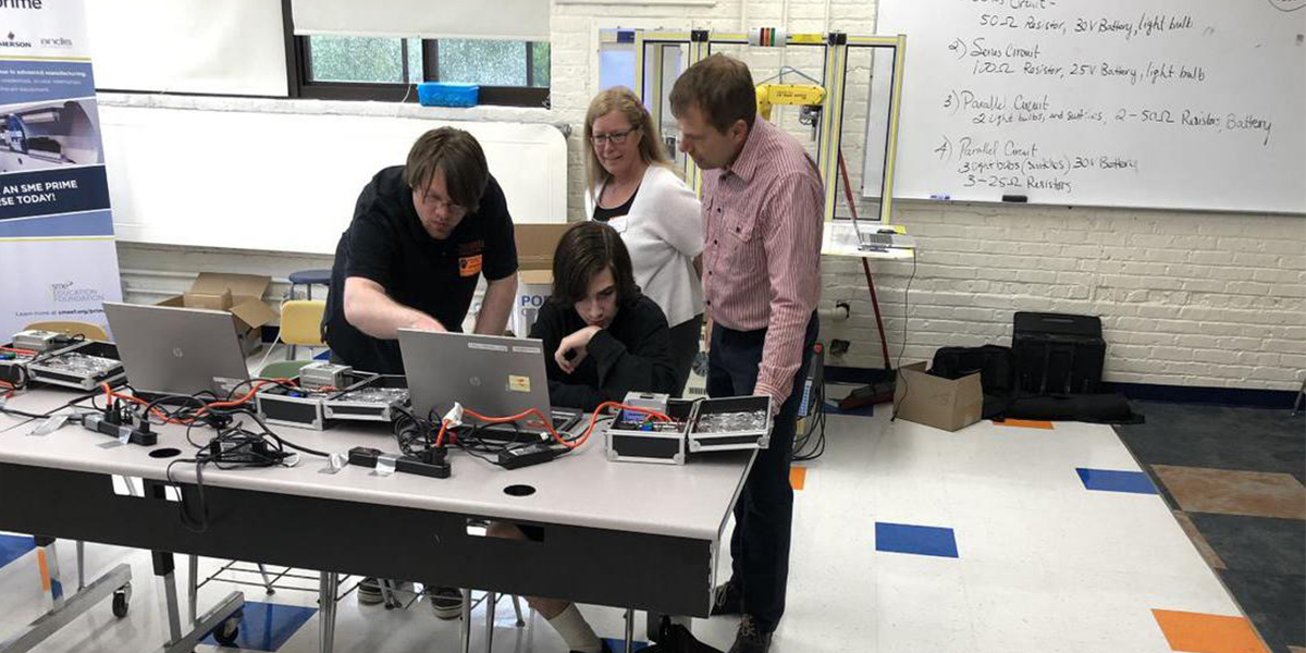 Dr. Travis Sossaman, Nicole Ryan and Dr. Jeff Wilkins working with a student