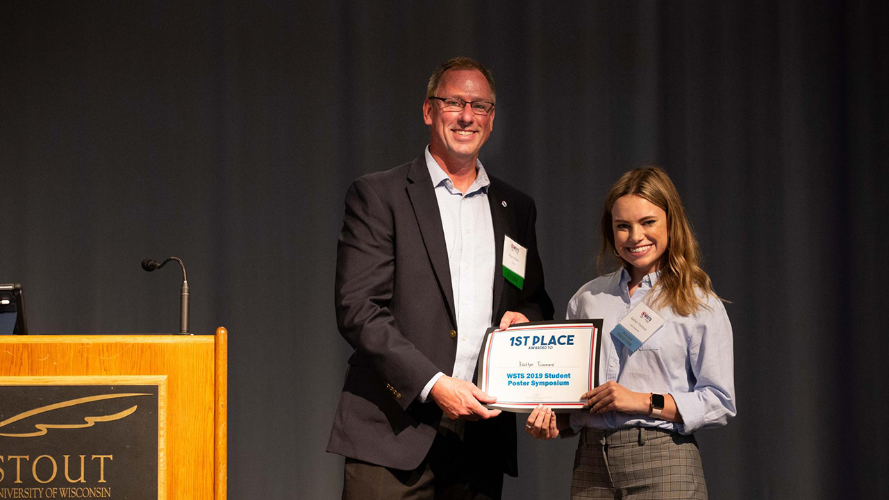 Kaitlyn Timmins receives first place for her research poster “Protecting the Planets from Microbial Contamination.”