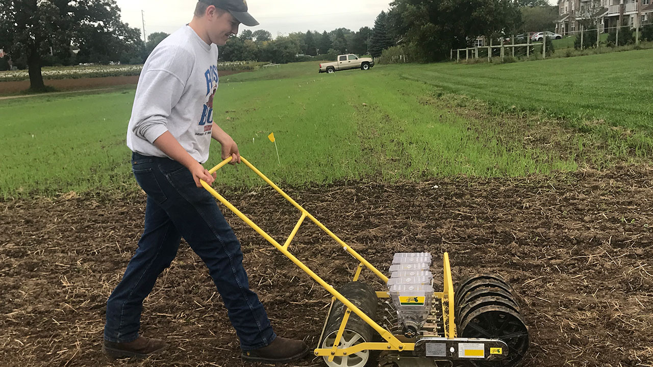 Ben Behlke works at the West Madison Agricultural Research Station, planting 10 varieties of pennycress at different dates throughout September and October.