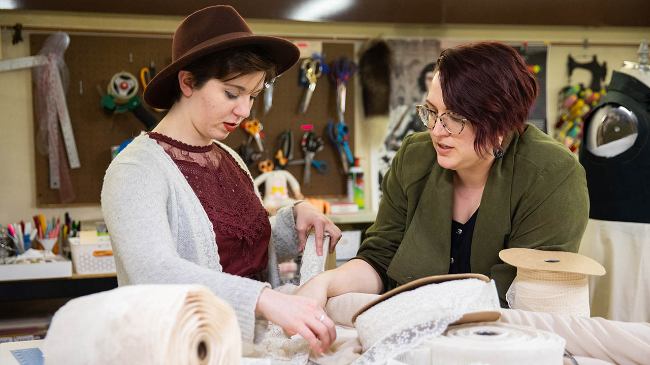 Blair Schuler discusses trim options with design mentor Sarah Strange in the UW-Platteville Costume Studio
