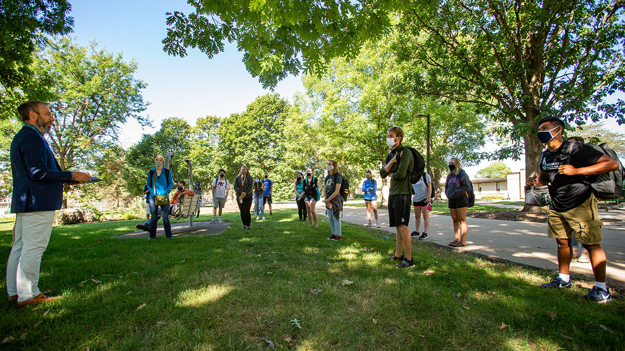 Professor Tyler Ostergaard teaches art history outside.