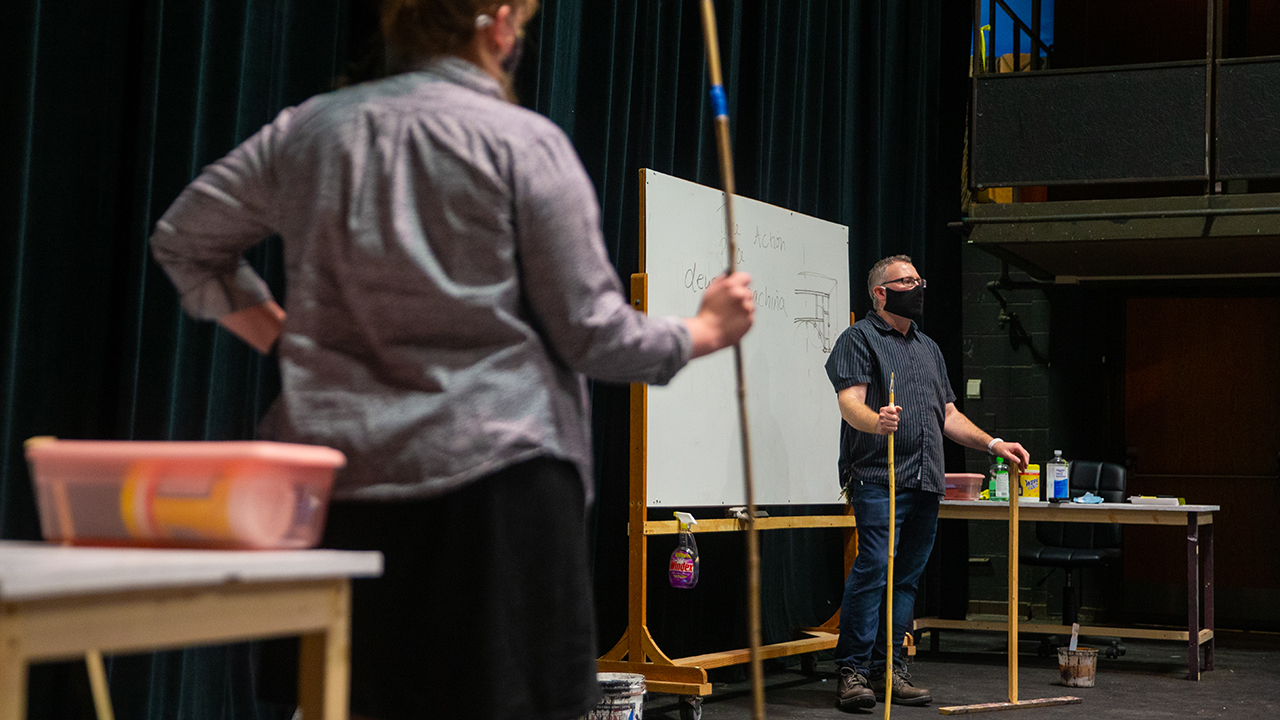 Jeffrey Strange, associate professor, works with students on scenic design.