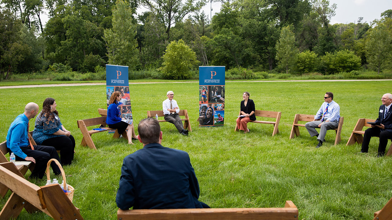 Gov. Evers meets with university leadership in Memorial Park, site of solar array