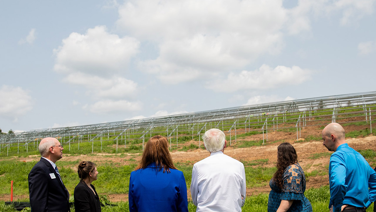 Gov. Evers meets with university leadership in Memorial Park, site of solar array