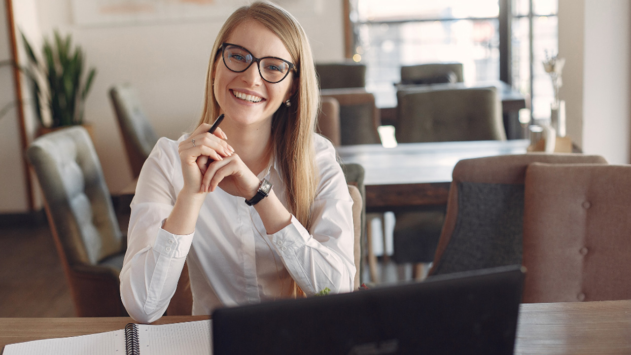 Woman sitting with laptop open