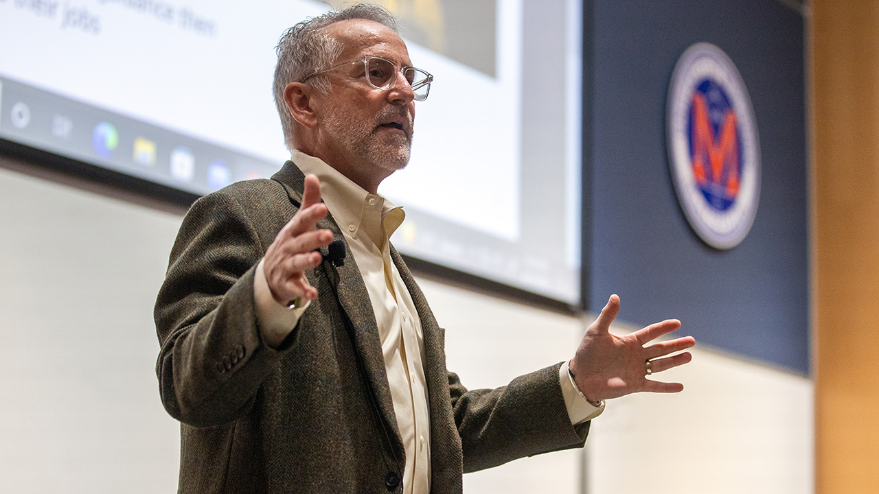 Tim Herrick speaks to audience in Doudna Hall