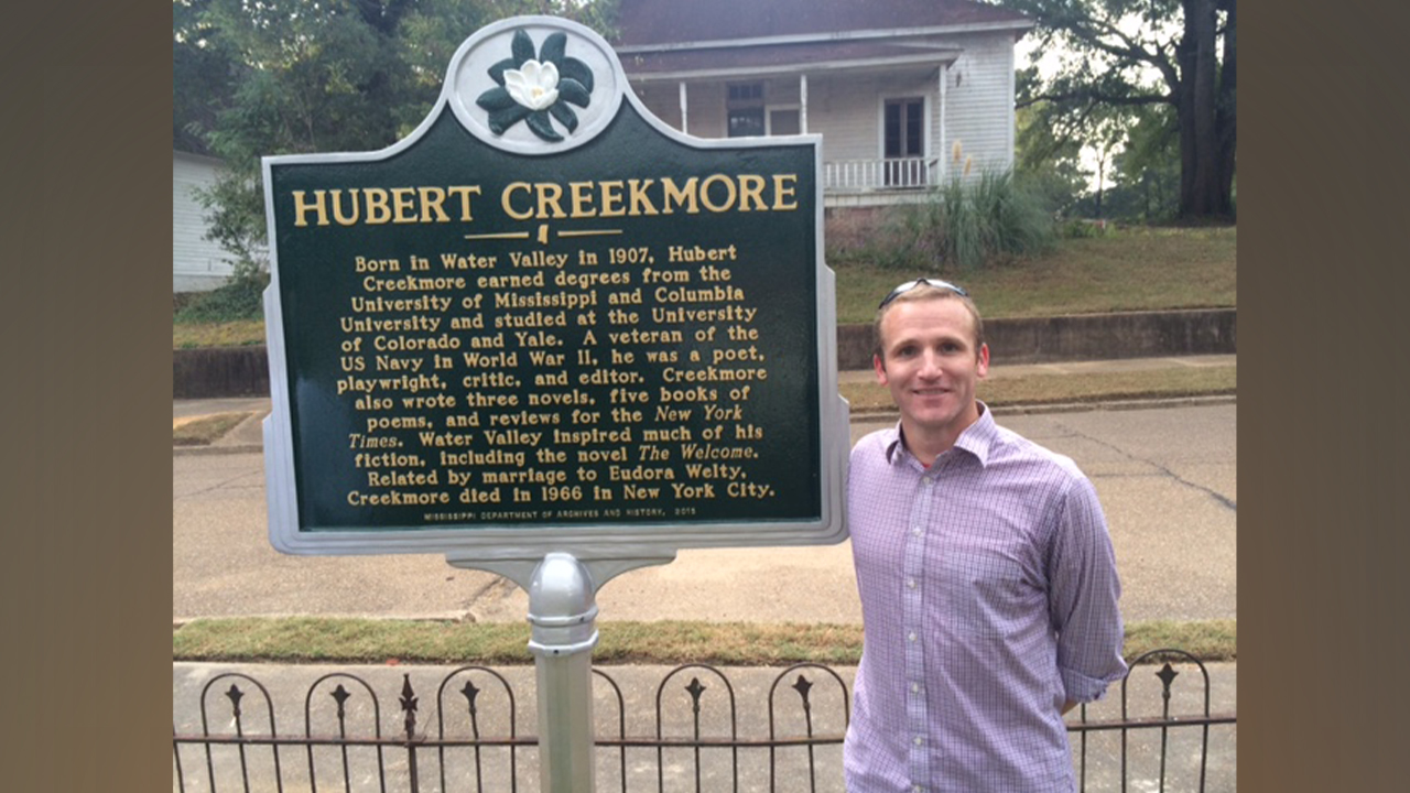 Dr. Philip Gordon next to Creekmore sign