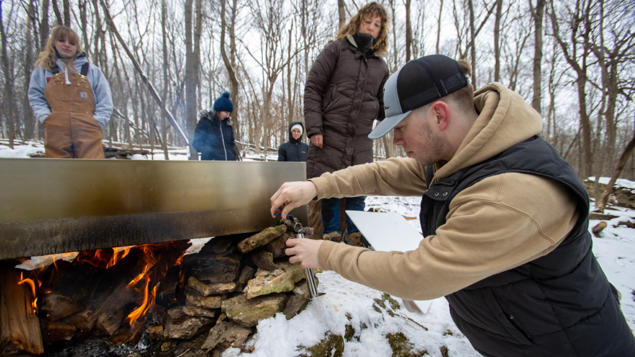 Dr. Laura Dev works with her students on the sugarbush project.