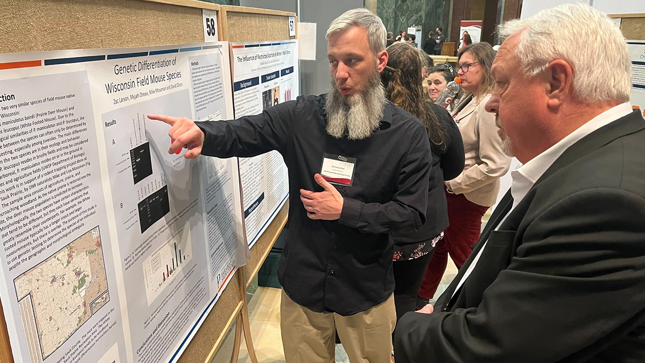 Zac Larson presents his research at Research in the Rotunda.