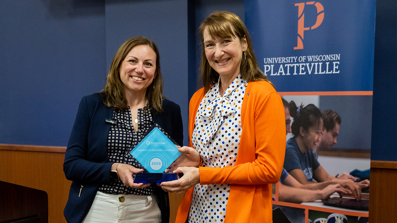 Tara Kiley, deputy administrator at the Public Service Commission of Wisconsin presents Chancellor Tammy Evetovich with the Energy Efficiency Excellence Award.