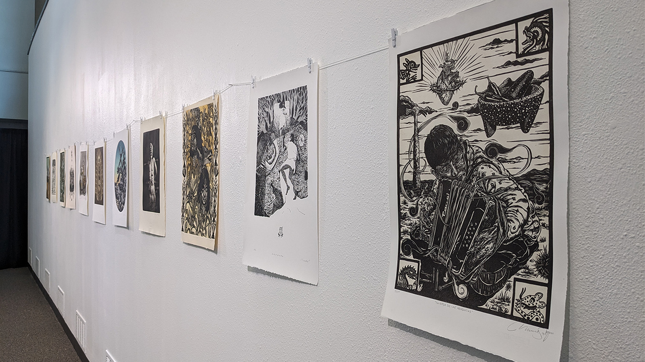 Prints by Marco Sanchez and Jacob Bautista hanging in Nohr Gallery