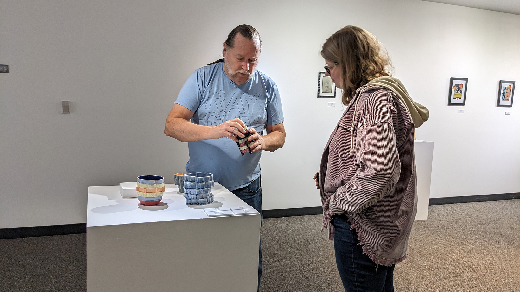 John J. Richard discusses his artwork with a student at the opening reception.