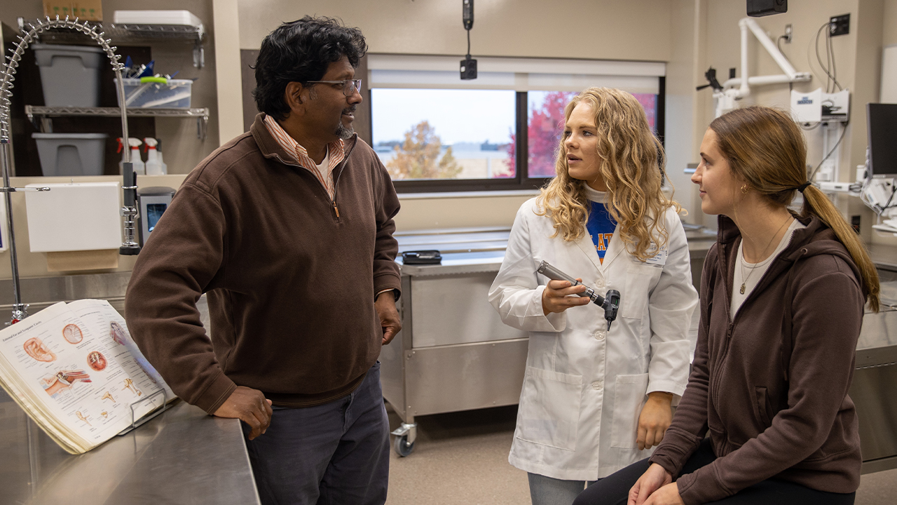 Dr. Rich Dhyanchand working with PA students in campus labs that closely resemble real-world healthcare settings.