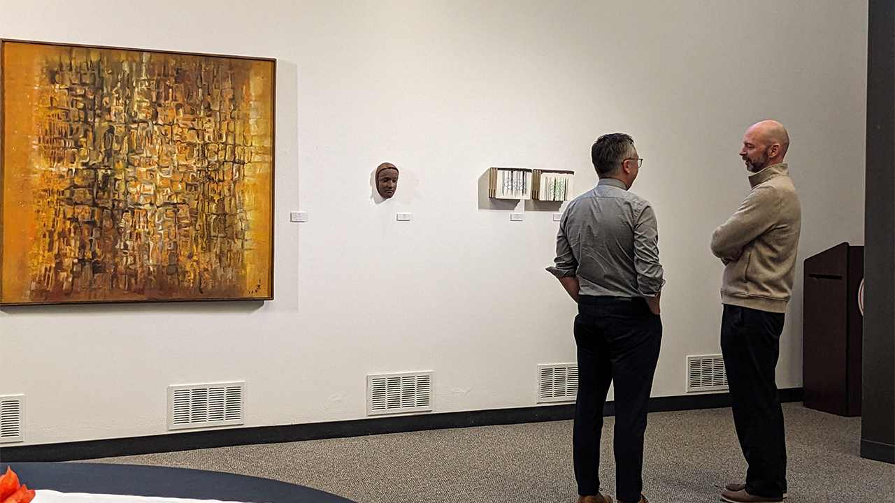 Guests mingle at the "Small Works Exhibition" artist reception.