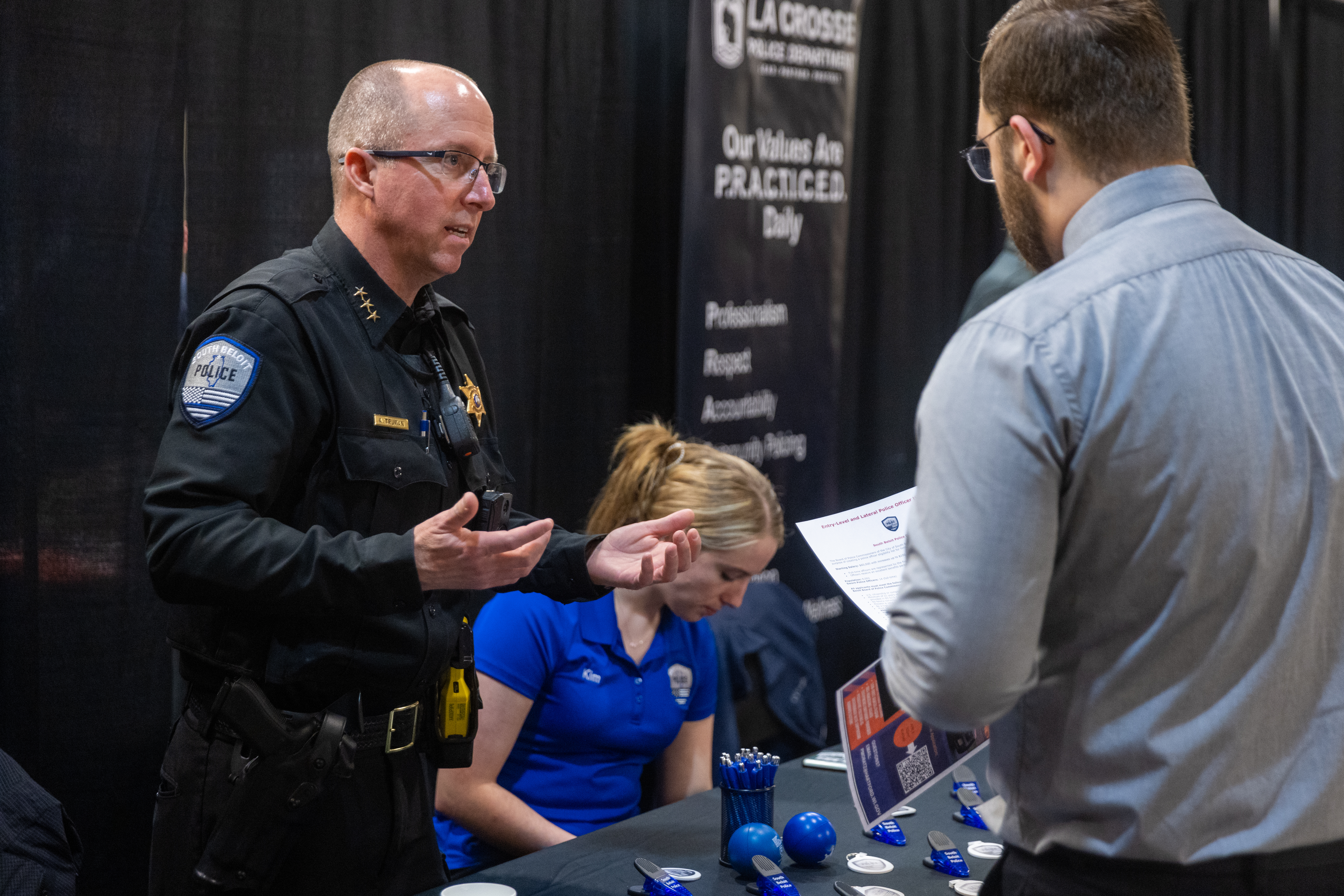Chief Adam Truman speaking with a student about a future in law enforcement. 