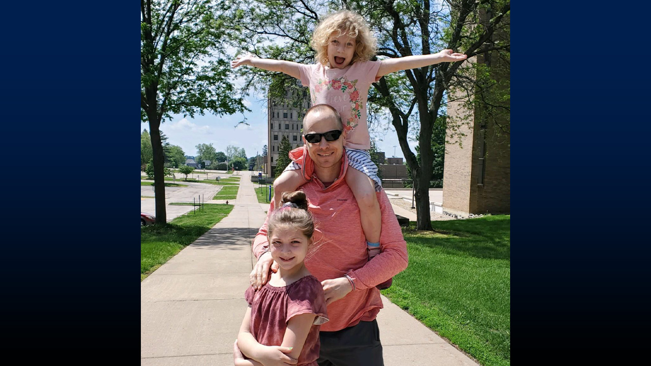 Frayer takes his daughters Nora and Eva for a walk around campus.