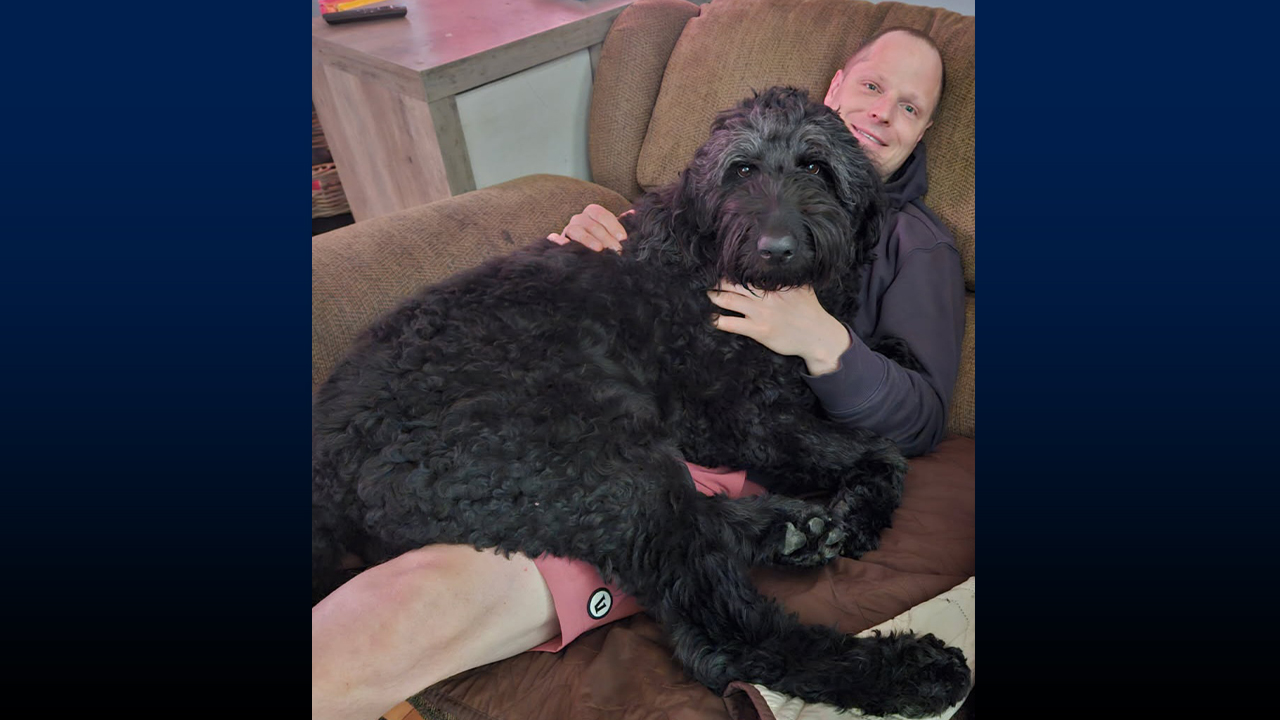 Frayer with his 80 pound lap dog, Luna.