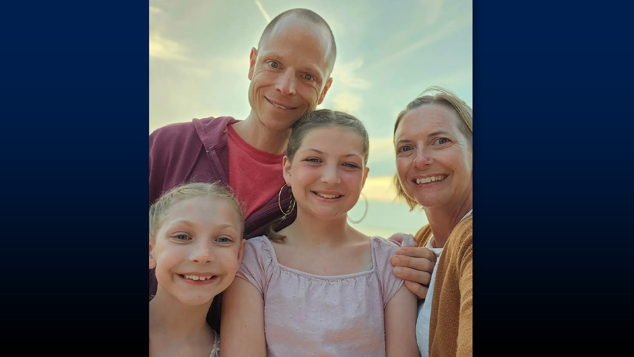 Frayer pictured with his wife, Kelly, and their daughters Nora and Eva.
