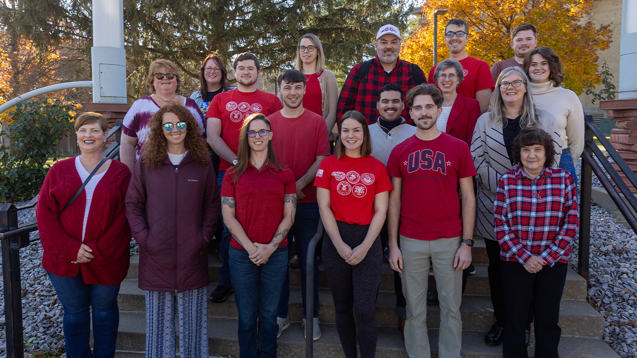 Robinson, pictured on the lower right, stands with colleagues during RED Friday—Remember Everyone Deployed—during Veterans Week, November 2024.