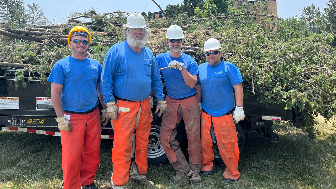 Dan McLaughlin, Jerry Olin, Ray Rickert and Travis Schute during tree trimming and cutting operations as part of ongoing landscape maintenance and safety efforts.