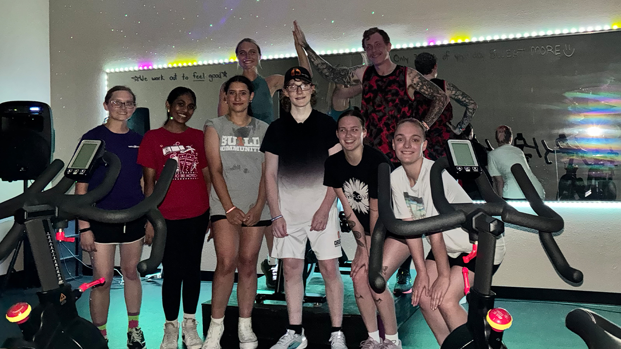 Instructor Alexia Reese poses with students Chance Huberty, Lillian Dalbey and Paige Atkinson following a high-energy spin class.