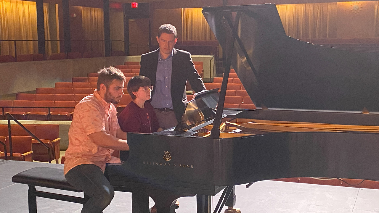 Ethan Squires and Elyse Harvancik work with pianist Geoffrey Duce during a master class.