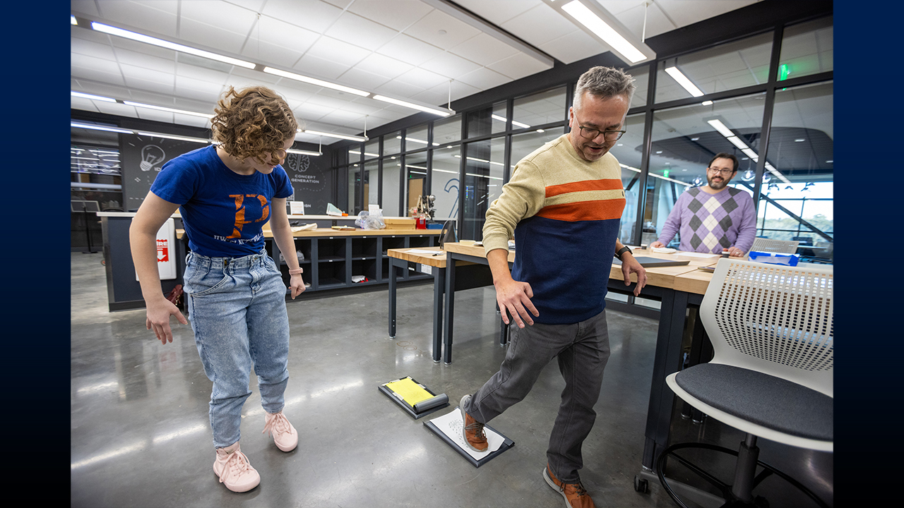 Dr. Travis Nelson, dean of the College of Liberal Arts and Education, adds his footprint to the Wisconsin State Crime Lab’s footwear database, demonstrating the process of capturing a powder-based impression.