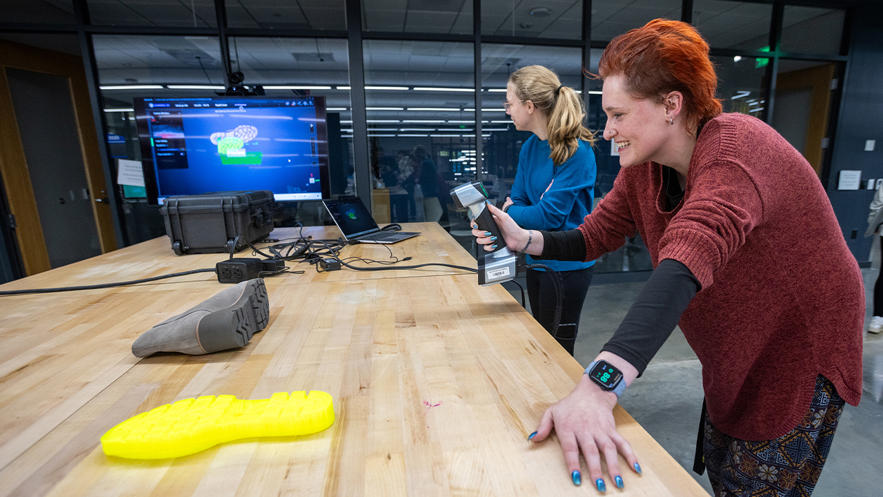 Senior Cassie Kniess operating the 3D scanner for evidence collection.