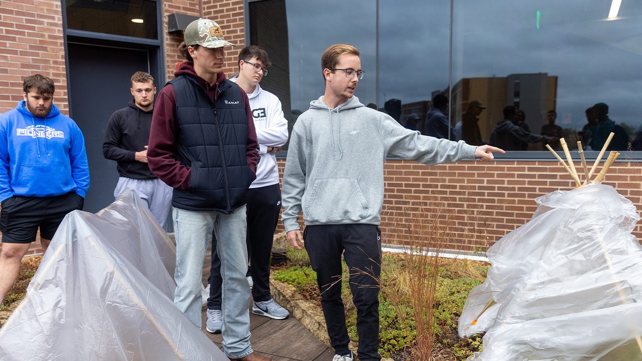 Freshman construction management major Thomas Woodard, pictured in the front in a ball cap, reflects on teamwork: “Through this tent project, I learned the importance of stepping back and not trying to do everything my own way.”