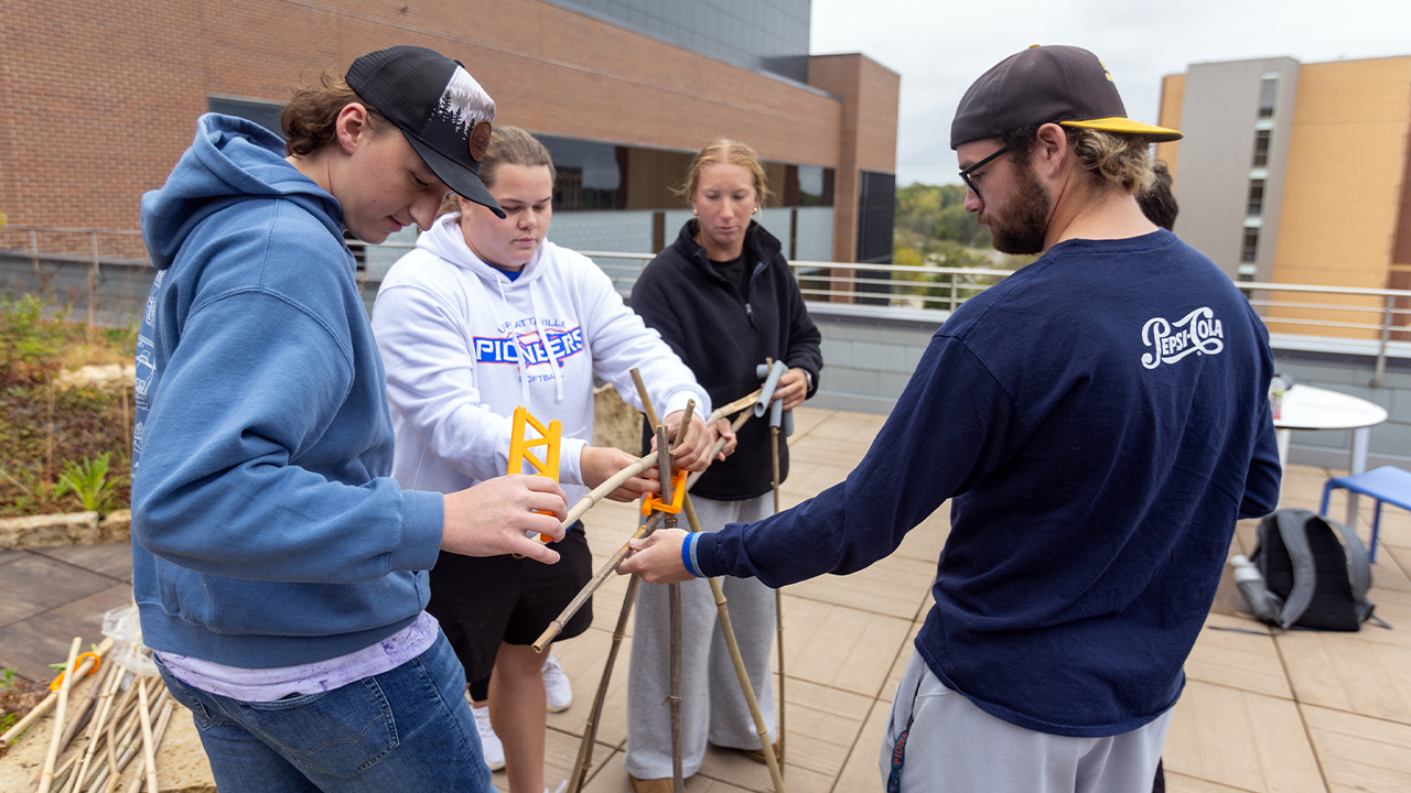 Senior Lane Breitsprecker, pictured to the left, helps present his team’s final camping prototype, an experience that concluded with each group explaining their design’s function, portability and practical application in outdoor education.