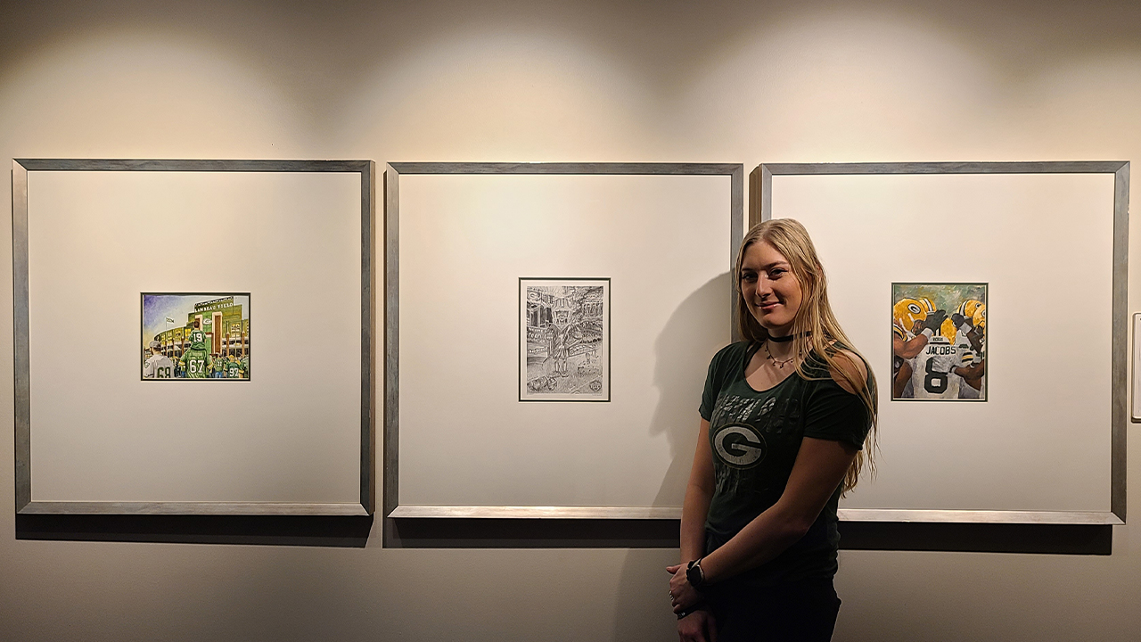 Schlorf with her artwork on display at Lambeau Field.