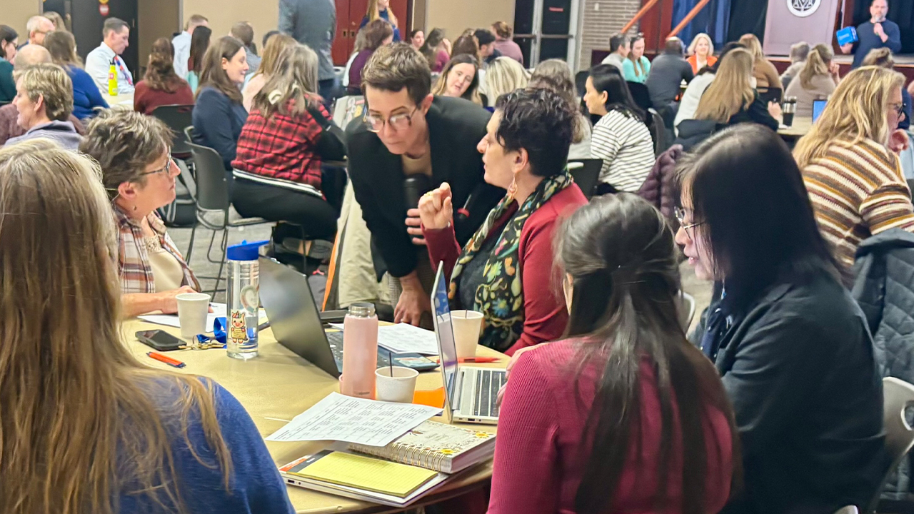 A group of women talking at a table. 