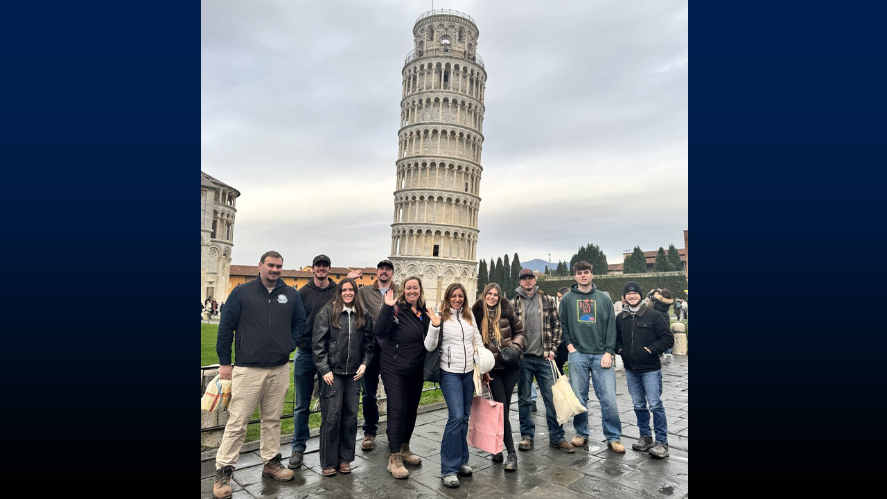 Group photo in front of the Leaning Tower of Pisa.