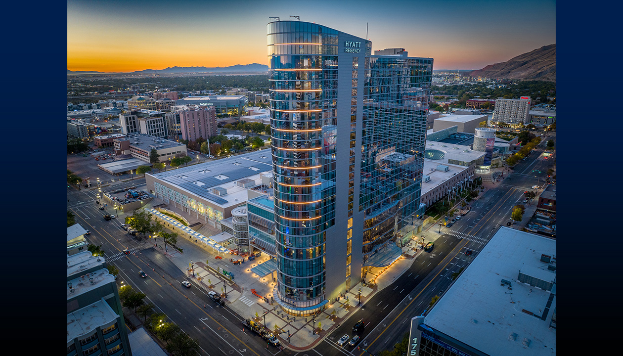 Drone footage of tall hotel in urban downtown areas at dusk