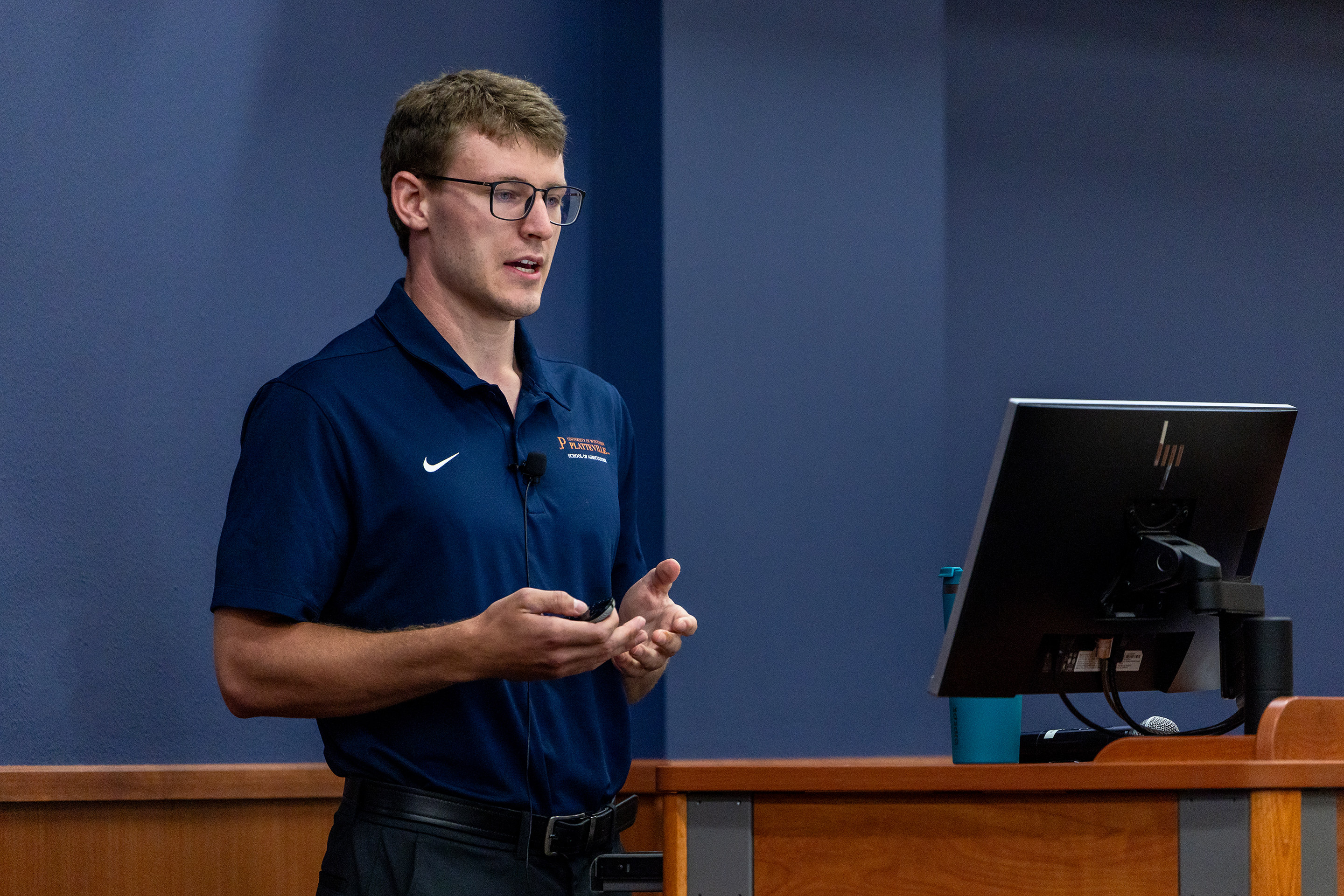 UW-Platteville junior Ethan Bode stands in front of a podium in a meeting room in the Markee Pioneer Student Center during his Summer Scholars presentation Monday, July 20, 2026.