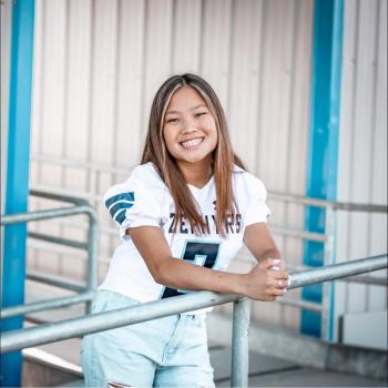 Aggi Kerwin poses in her high school football jersey.