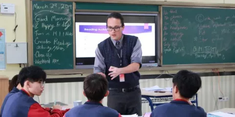 Charlie Schoenberg teaching at Guangwai-Pacelli High School