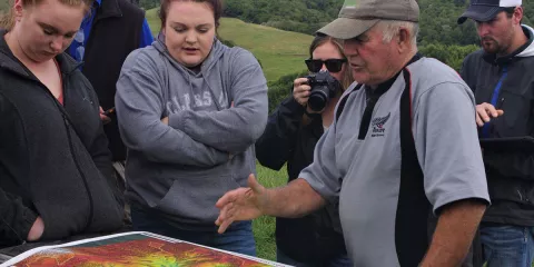 Agriculture students in New Zealand reviewing an elevation map