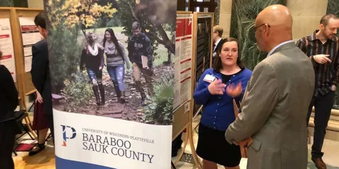 Chancellor Shields speaking with a Baraboo student at Research in the Rotunda