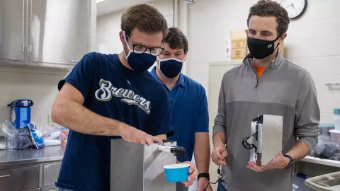 Mechanical engineering students work on ice cream dispenser for Pioneer Sweets