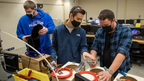 Team of students work on cooling device for coffee maker