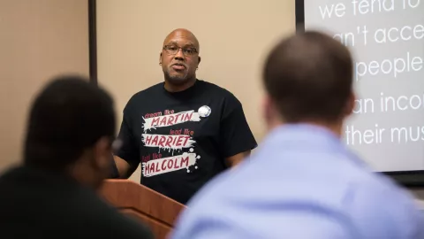 Dr. Frank King speaking at a prior event