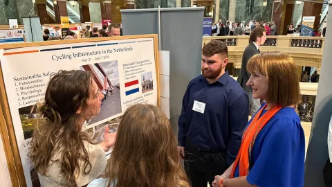 Students share their research on cycling infrastructure in the Netherlands with Chancellor Evetovich. 