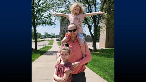 Frayer takes his daughters Nora and Eva for a walk around campus.