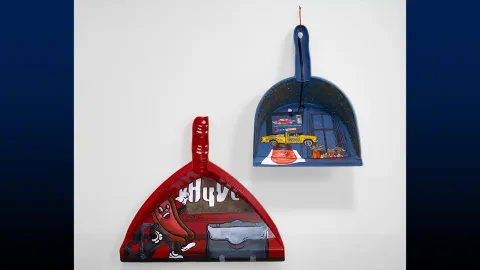 Mixed media dustpans created by Kobe Elixson and Zoё Couvillion.
